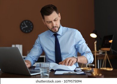 Male Lawyer Working With Laptop In Office