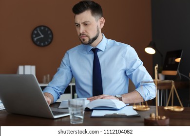 Male Lawyer Working With Laptop In Office