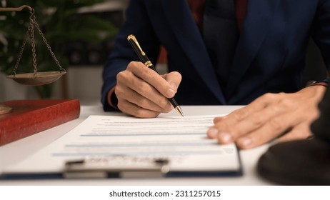 Male lawyer working with law book, A legal binding, Unilateral contract, Multilateral, Non-reciprocal contract, Default, Obligation, Power of attorney, Defense of a prescription, Court decree - Shutterstock ID 2311257015
