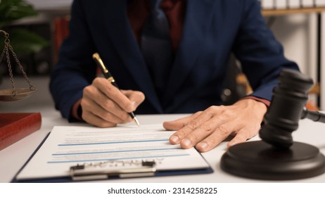 Male lawyer working with law book, A legal binding, Unilateral contract, Multilateral, Non-reciprocal contract, Default, Obligation, Power of attorney, Defense of a prescription, Court decree - Shutterstock ID 2314258225