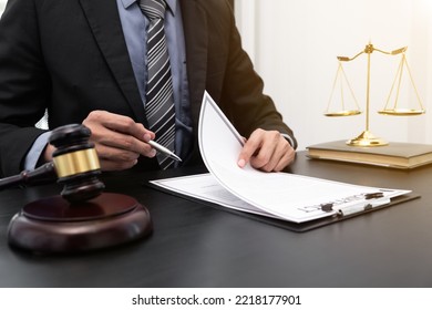 Male lawyer working with lawsuit papers on tabel in courtroom. justice process and law, attorney, court judge, concept. - Shutterstock ID 2218177901