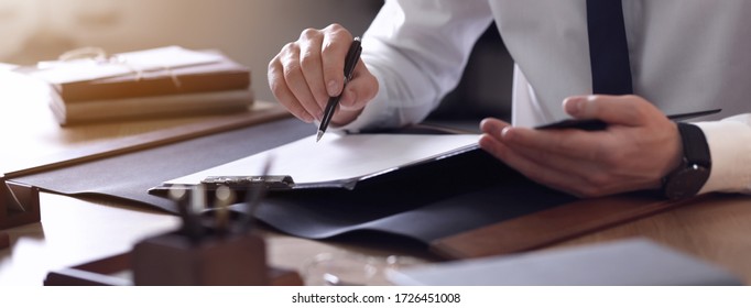 Male lawyer working at table in office, closeup. Banner design