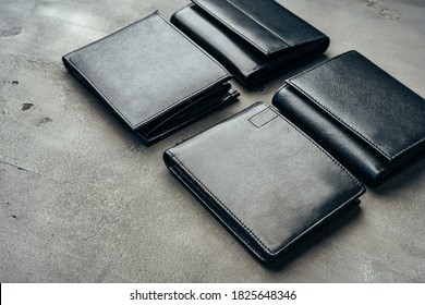 Male leather wallets on grey concrete background