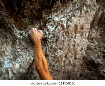 male left hand with chalk powder in cliff climbing sport, Ao Nang, Krabi, Thailand.