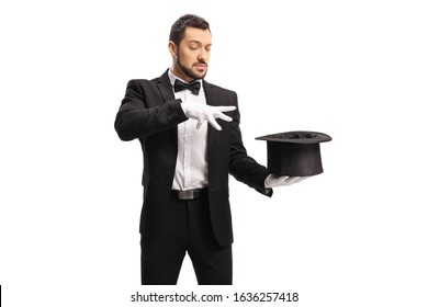 Male Magician Performing A Trick With Hands And A Top Hat Isolated On White Background