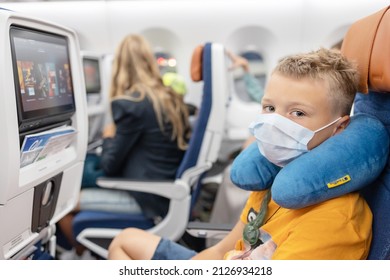 Male, Maldives - July 2021: Teenage Boy Passenger Generation Z On The Plane Sit And Watching Movie In Protective Face Mask, Summer Holidays, Public Transport