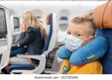 Male, Maldives - July 2021: Teenage Boy Passenger Generation Z On The Plane Sit And Watching Movie In Protective Face Mask, Summer Holidays, Public Transport