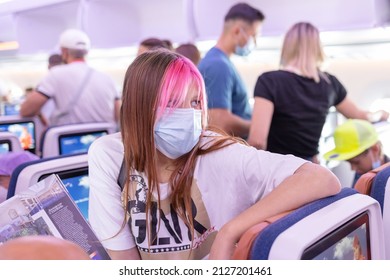 Male, Maldives - July 2021: Teenage Girl Passenger Generation Z On The Plane Getting Ready To Go Out During The Summer Holidays, Public Transport