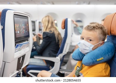 Male, Maldives - July 2021: Teenage Boy Passenger Generation Z On The Plane Sit And Watching Movie In Protective Face Mask, Summer Holidays, Public Transport