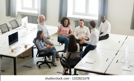 Male Manager Coach Mentor Speaking At Corporate Group Business Meeting, Team Leader Talking To Workers Training Interns At Workshop Explaining New Project Strategy In Office, Top View Overhead Above