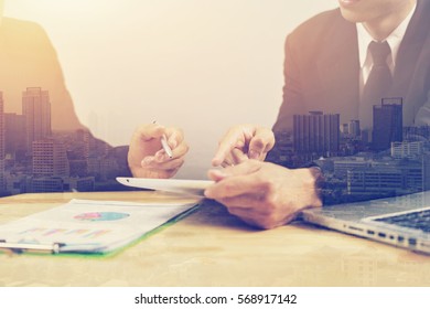 Male Manager Discussion Ideas And Writing Business Plan At Workplace,Two Student Holding Pens And Papers Book For Analyzing Financial Lesson,notes Documents,laptop Pc On The Table, Double Exposure 