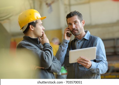 male manager in hard hat making a phone call - Powered by Shutterstock