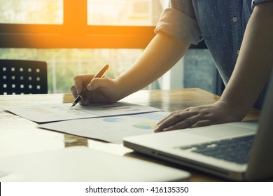 Male Manager Putting His Ideas And Writing Business Plan At Workplace,man Holding Pens And Papers, Making Notes In Documents, On The Table In Office,vintage Color,morning Light ,selective Focus.