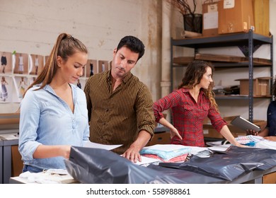 Male Manager With Trainee Packing Orders For Distribution