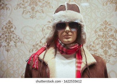 Male mannequin in knitted sweater, sunglasses, fur jacket , leather hat and red scarf, casual clothes. winter season.  - Powered by Shutterstock