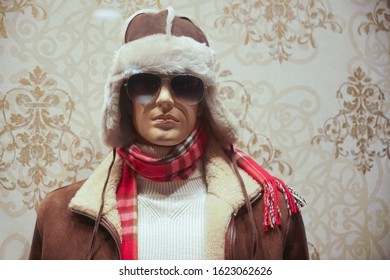 Male mannequin in knitted sweater, sunglasses, fur jacket , leather hat and red scarf, casual clothes. winter season.  - Powered by Shutterstock