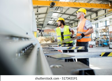 Male Manual Workers Manufacturing Sheet Metal At Industry