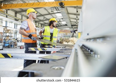 Male Manual Workers Manufacturing Sheet Metal At Industry