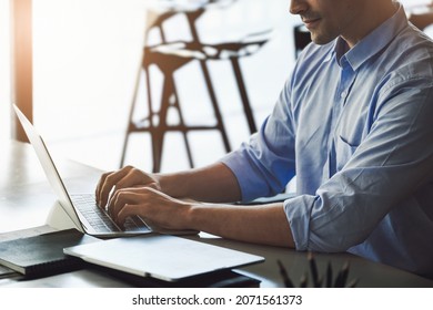 A male marketing manager using a computer to design a company's sales plan to present work to potential venture capitalists to maximize profits. - Shutterstock ID 2071561373