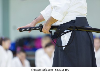 A male martial arts instructor with katana on seminar