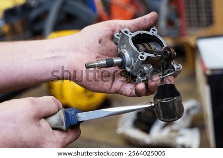 male master repairs engine piston crankshaft two-stroke engine