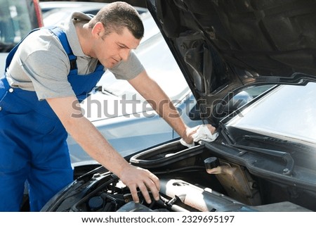 male mechanic is checking the car