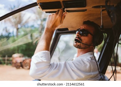 Male mechanic or pilot examining helicopter. Pre flight inspection at the helipad - Powered by Shutterstock