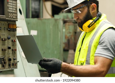 Male Mechanical Engineer Is Using The Laptop To Check The Volume Of The Machine And Set Up The System At The Mechanical Control Room.