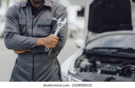 The male mechanic's hand holds the wrench Are showing solidarity with colleagues , Concept of engineer and auto repair - Powered by Shutterstock