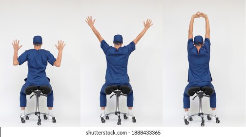 Male medical professional stretching arms and back sitting on mobile saddle - back view	
