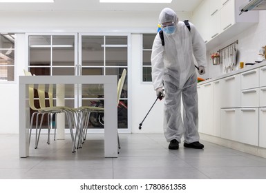 Male medical staff wearing PPE suits to protect against COVID-19 using nebulizers. And use chemicals disinfecting in kitchens and dining tables and chairs to prevent the risk of coronavirus outbreaks.