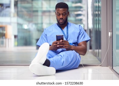 Male Medical Worker In Hospital Addicted To Using Mobile Phone At Work