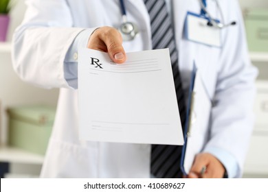 Male medicine doctor hand hold clipboard pad and give prescription to patient closeup. Panacea and life save, prescribe treatment, legal drug store, contraception concept. Empty form ready to be used - Shutterstock ID 410689627