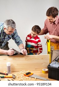 Male Members Of The Family Spending Time Together In A Woodshop