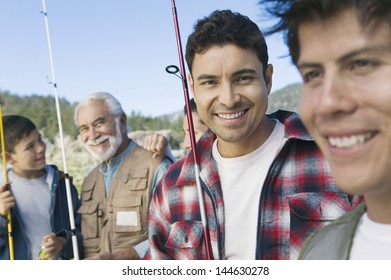 Male Members Of Three Generation Family On Fishing Trip Focus On Mid Adult Man (portrait)