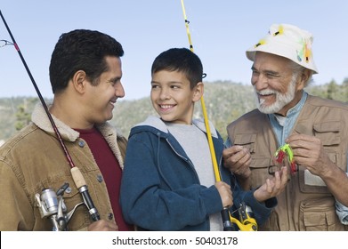 Male Members Of Three Generation Family On Fishing Trip, Smiling