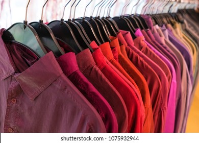 Male Mens Shirts Sorted In Color Order On Hangers On A Shop Wardrobe Closet Rail