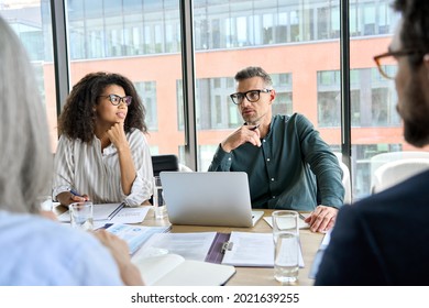 Male Mentor Leader Manager Talking To Colleagues Executive Team, Diverse Partners Group At Executive Board Room Meeting. Multicultural Professional Business People Discussing Project Plan In Office.