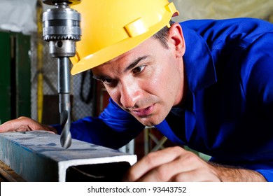 male metal worker using drillpress - Powered by Shutterstock