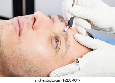 Male Microblading Procedure To Improve The Condition Of A Man’s Eyebrows In A Beauty Salon.
