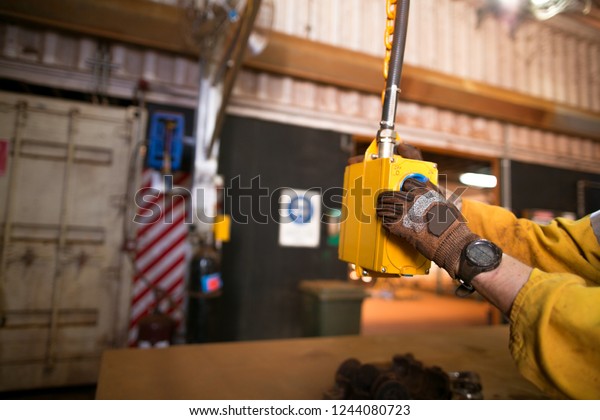 Male miner electrician worker hand wearing a glove\
inspecting internal power point outlet ensure it safe to use prior\
performing task inside construction  work shop, mine site, Perth,\
Australia 