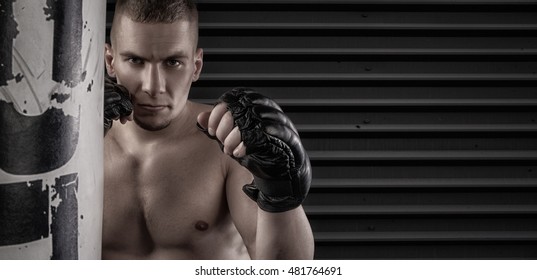 Male Mma Fighter In Gloves Dark Background