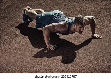 Male Model Performs Pushup On Floor.