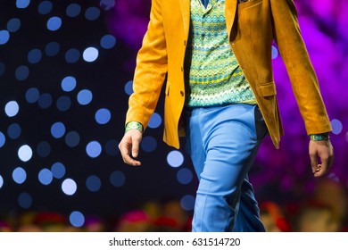 A Male Model Walks The Runway In Beautiful Colourful Suit During A Fashion Show. Fashion Catwalk Event Showing New Collection Of Clothes.