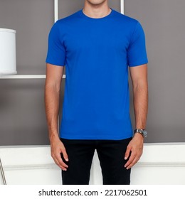 male model wearing a plain blue short sleeve t-shirt