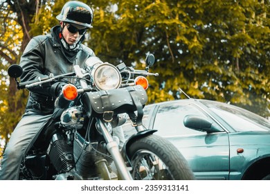 male motorcyclist on a custom chopper motorcycle wearing a helmet. - Shutterstock ID 2359313141