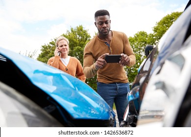 Male Motorist Involved In Car Accident Taking Picture Of Damage For Insurance Claim - Shutterstock ID 1426536872