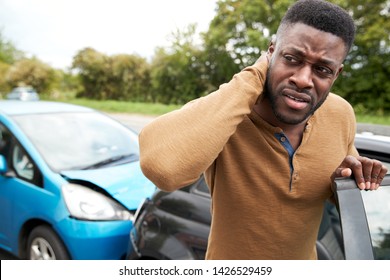 Male Motorist With Whiplash Injury In Car Crash Getting Out Of Vehicle - Shutterstock ID 1426529459