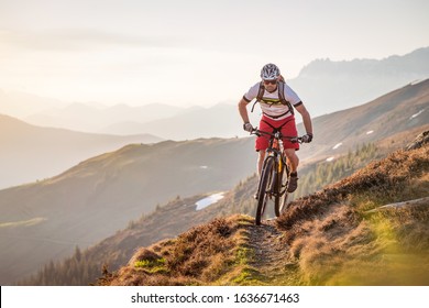 Male mountainbiker riding on a trail in the mountains