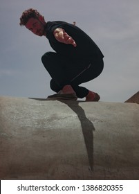 Male Movement Artist Dancing In An Empty Skatepark, Casting A Shadow Into The Skate Pool, From Where The Photo Is Shot.